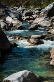 Rocce grigie e acqua mossa sul fiume durante il giorno